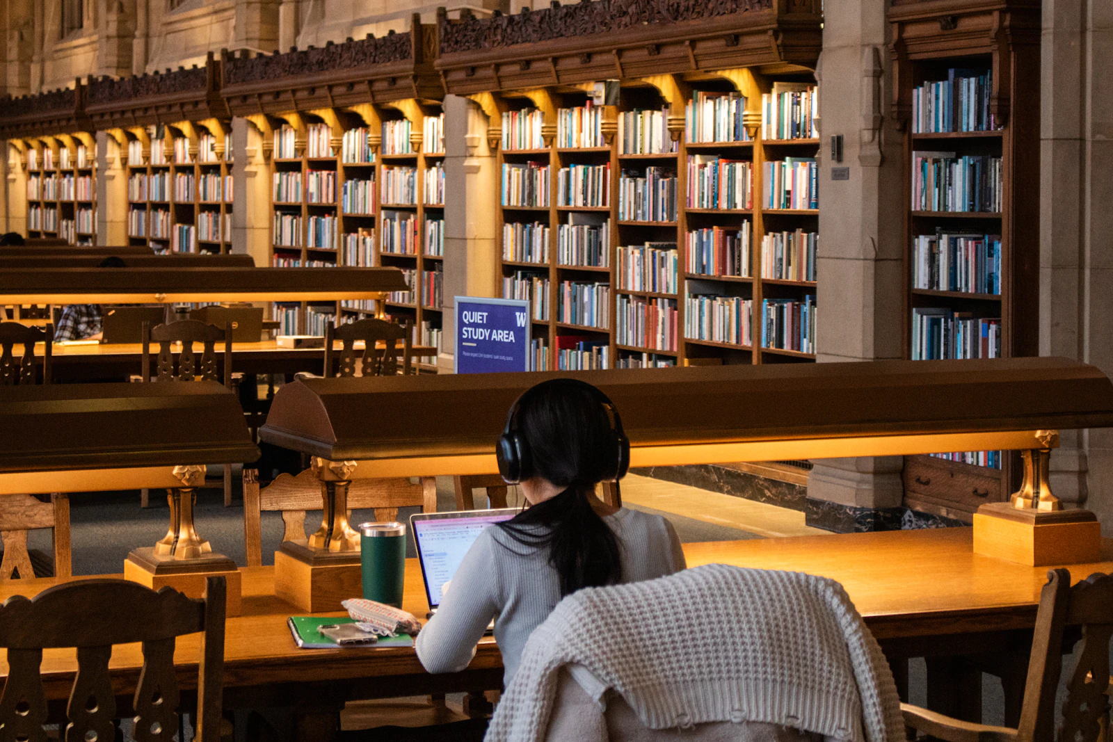 Student studying at a table in a university library