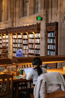 Student studies in a beautiful, historic library.