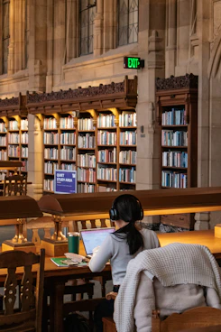 Student studies in a beautiful, historic library.