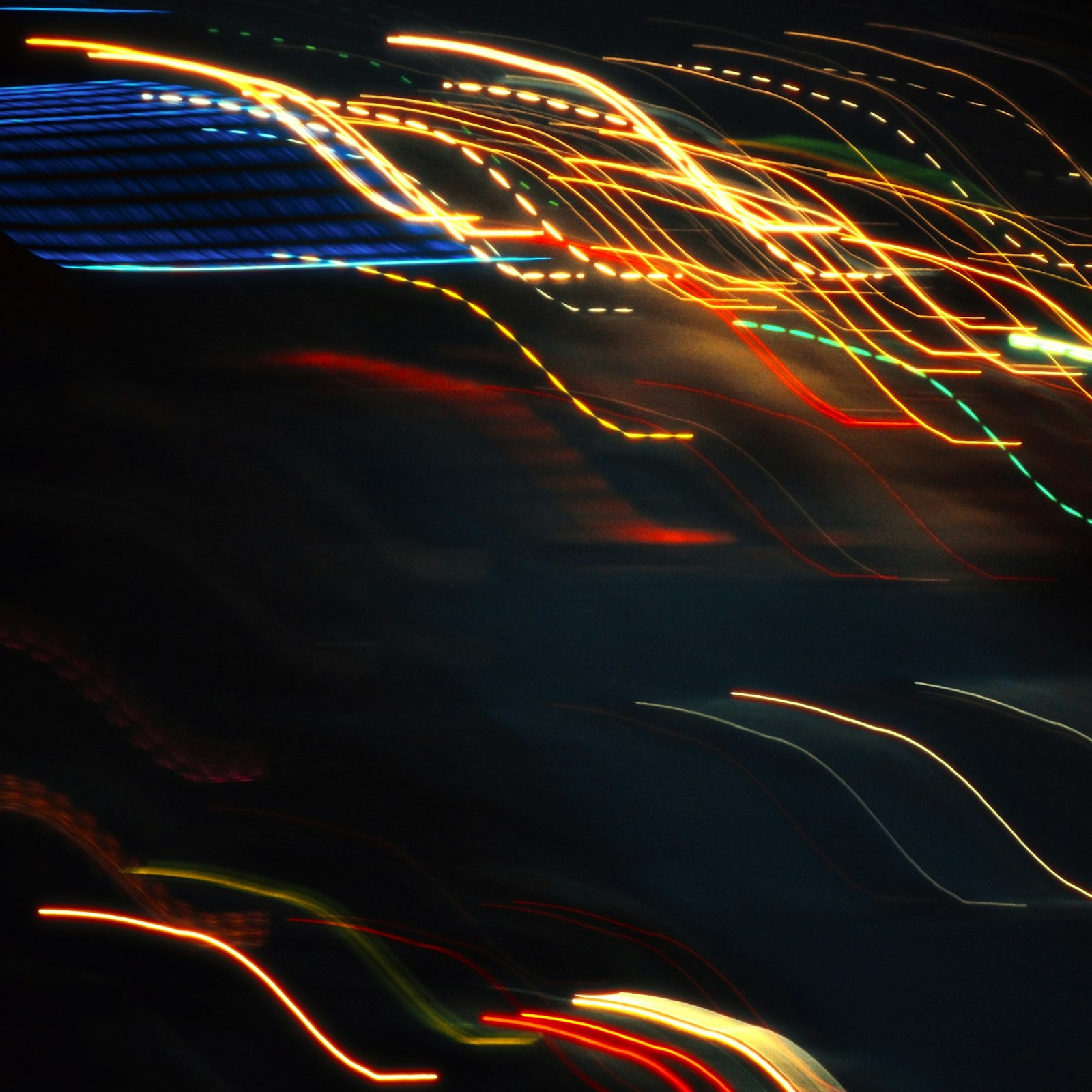 Abstract light trails streaking against a dark background