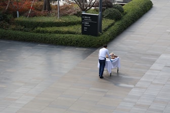 A man is pushing a cart with food.