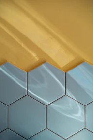 Blue tile and yellow wall with reflections.