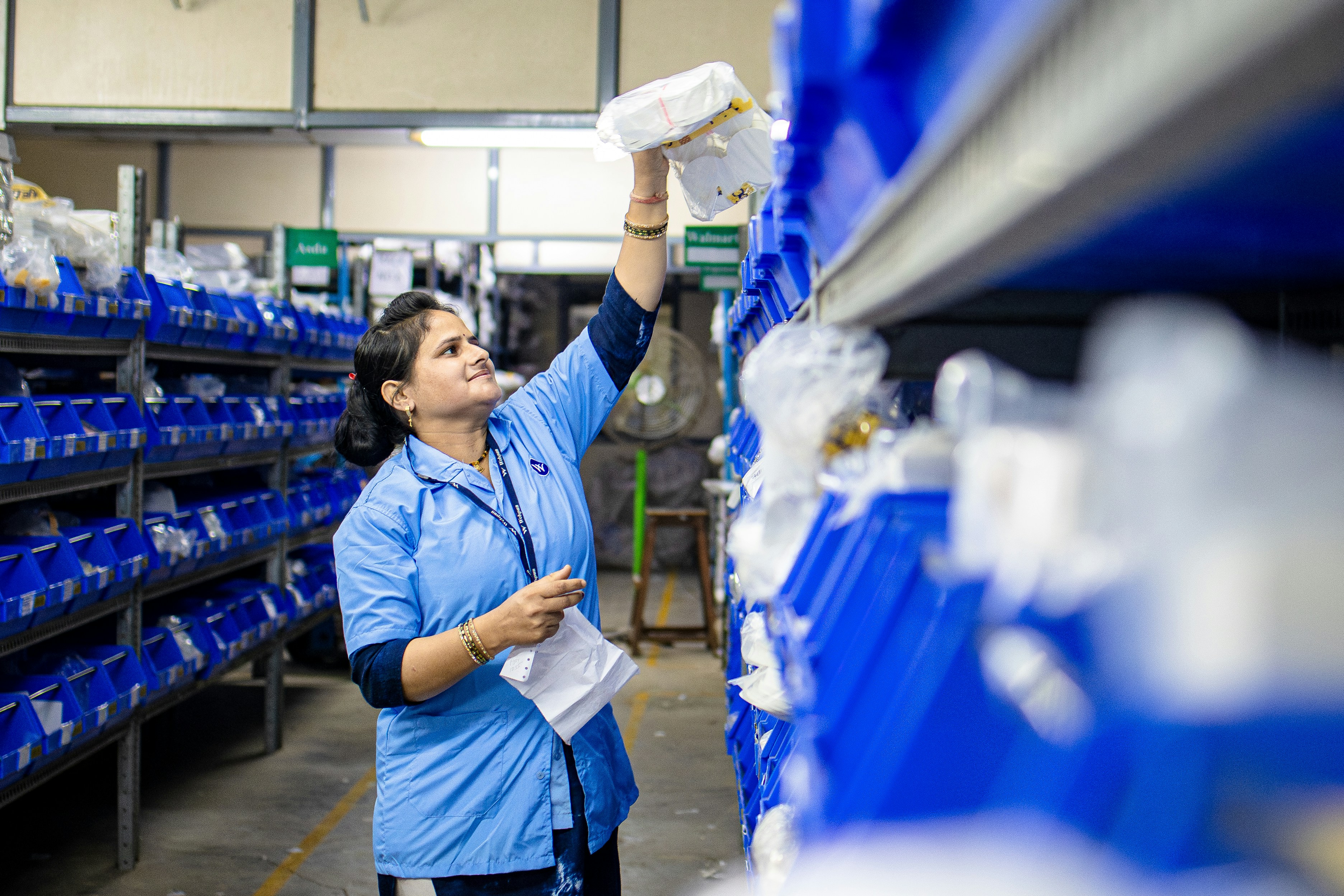 warehouse worker using a handheld scanner to track inventory - warehouse general labor