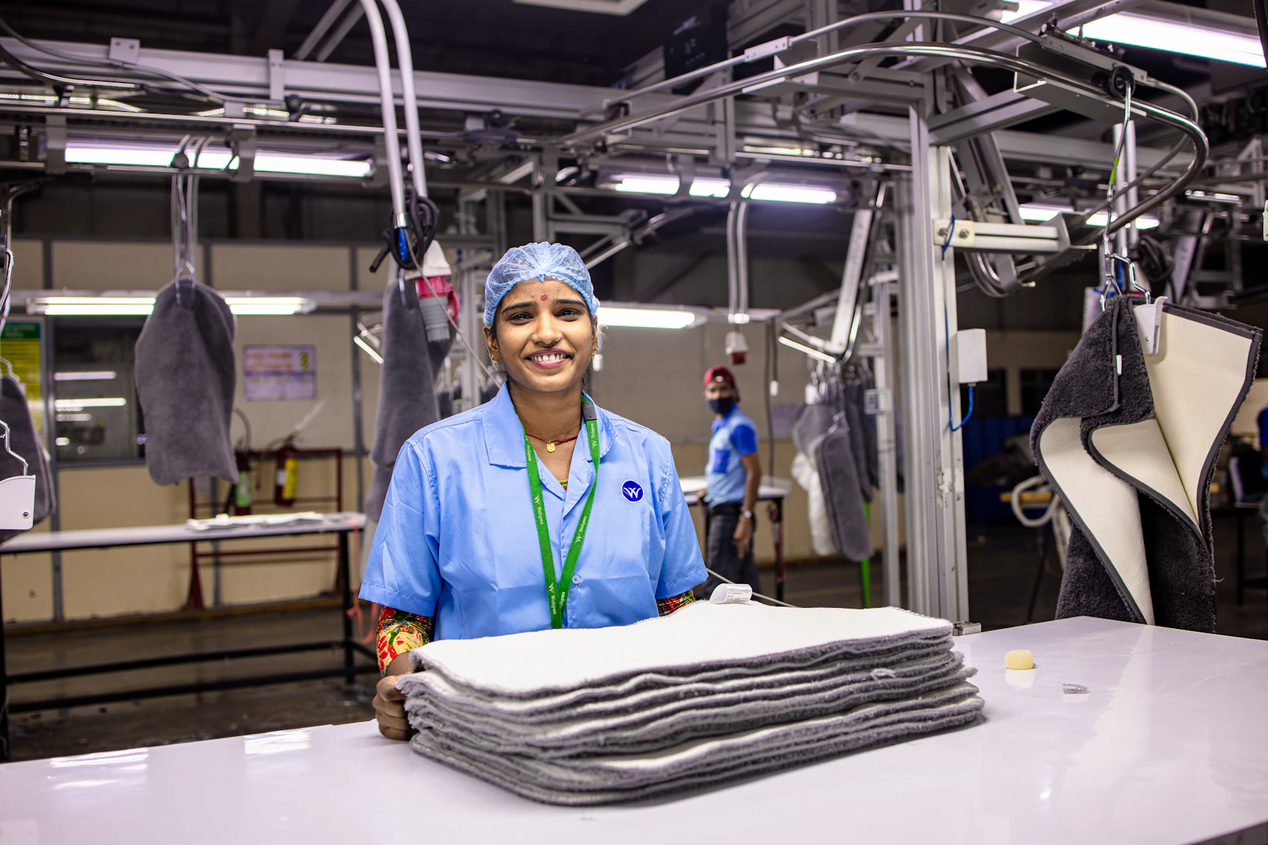 Worker smiling in a manufacturing plant