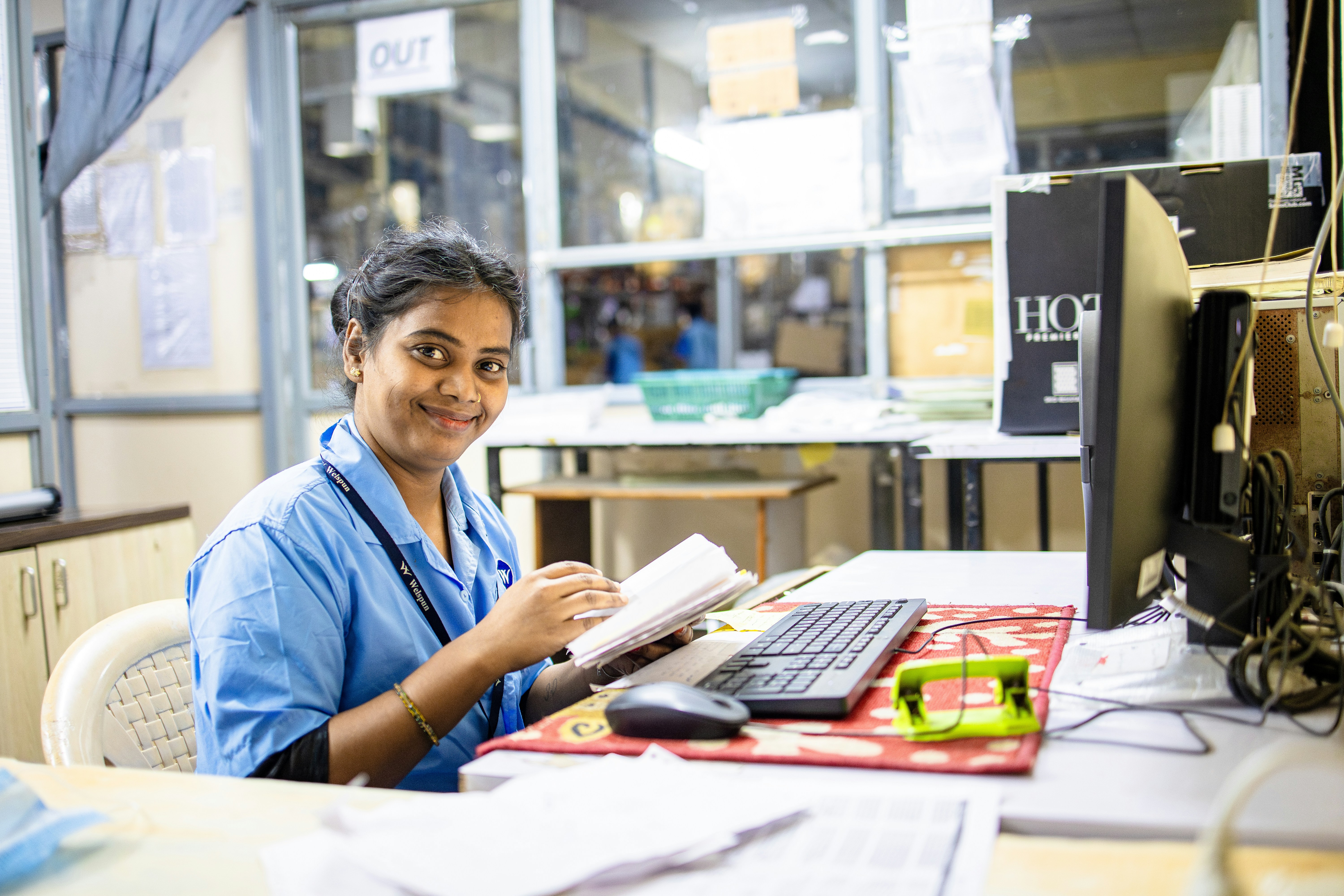 Woman works at a desk in an office.