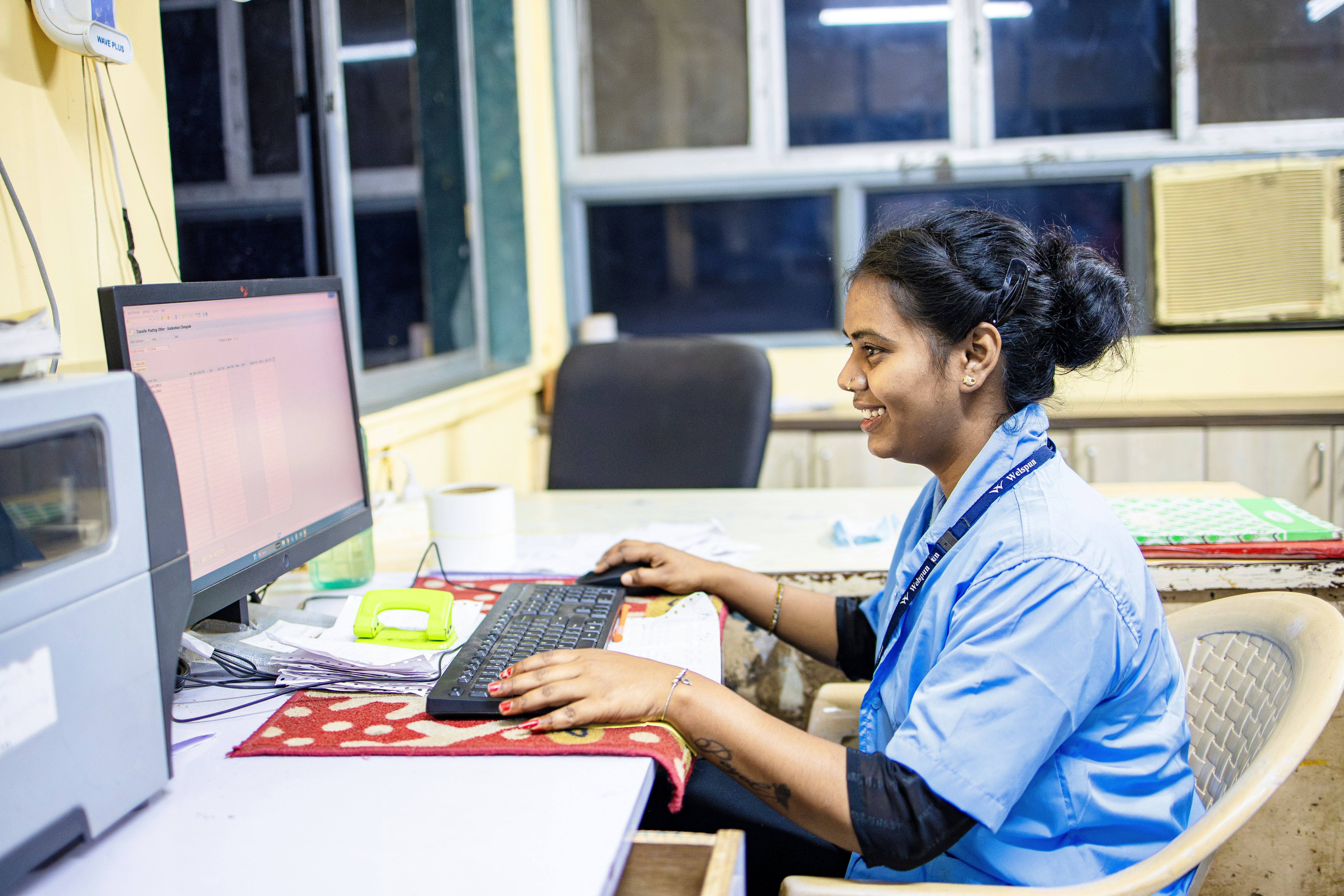Woman smiling while working on computer