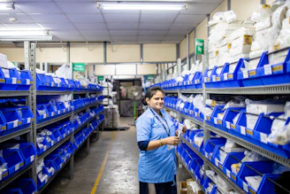 A woman works in an organized warehouse