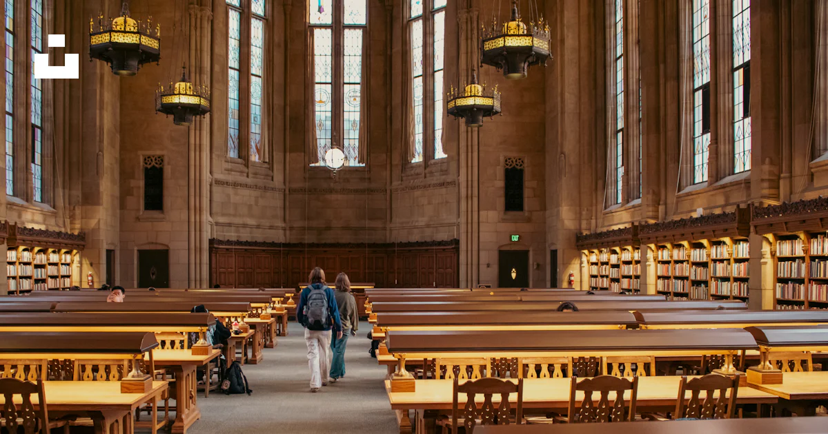 Students walk through a beautiful library with bookshelves. photo ...