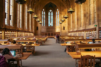 A grand library with high ceilings and bookshelves.