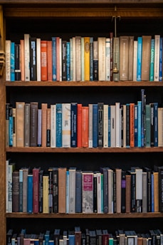 Bookshelves are filled with numerous, colorful books.