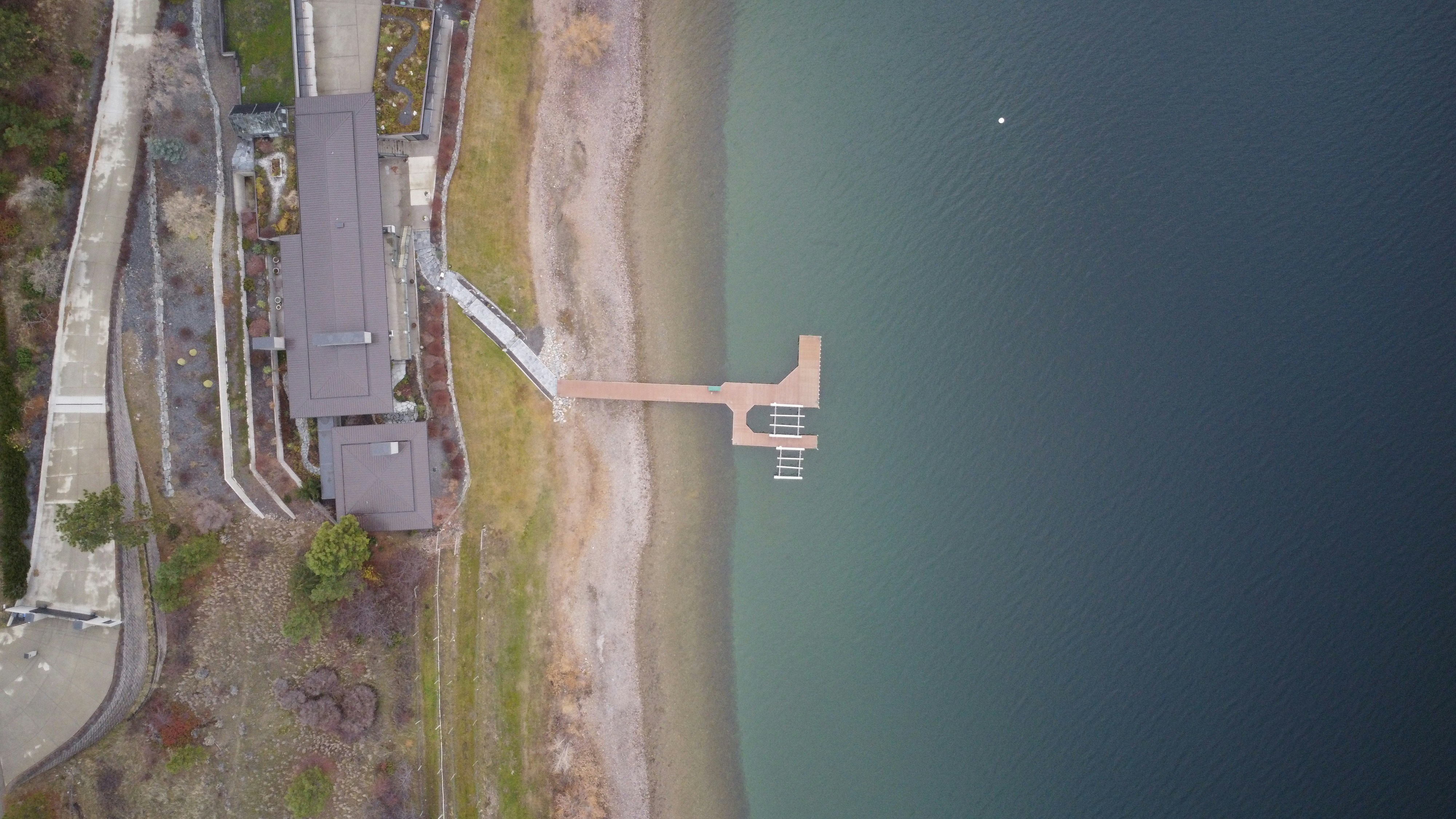 Drone flying over a waterfront property - real estate photography pricing