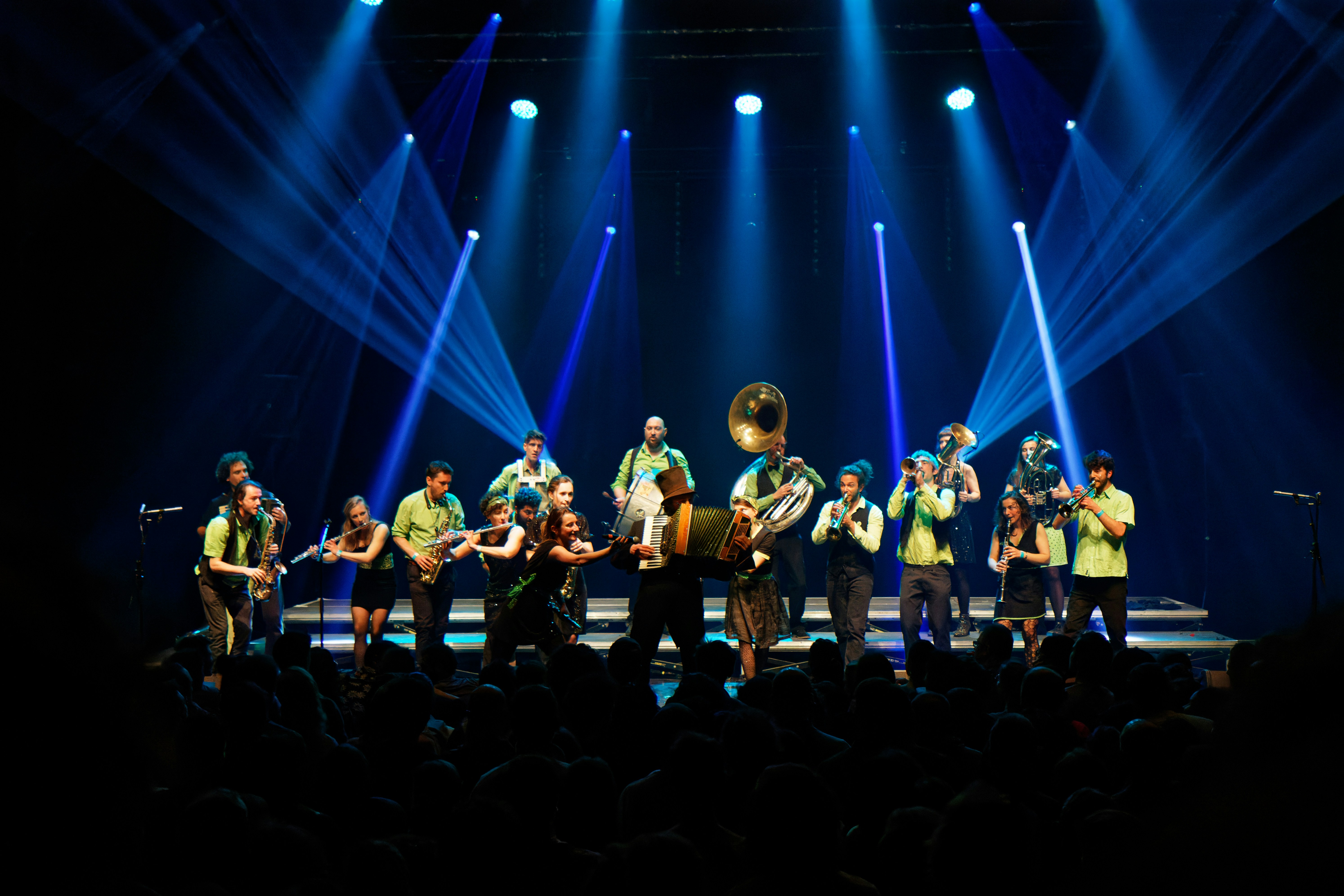 A band performs on a brightly lit stage.