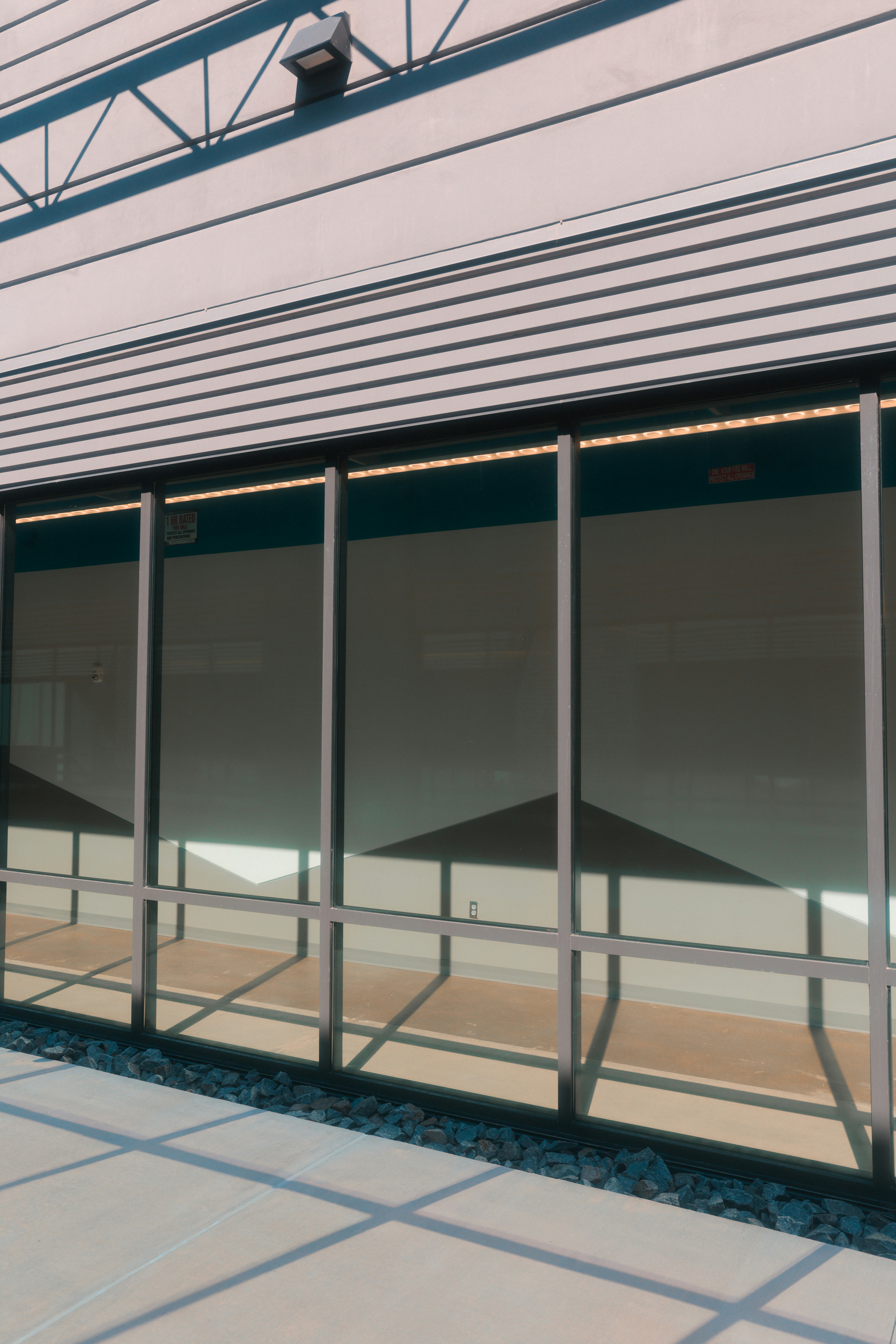 Building exterior with large glass windows and shadows. photo – Free ...