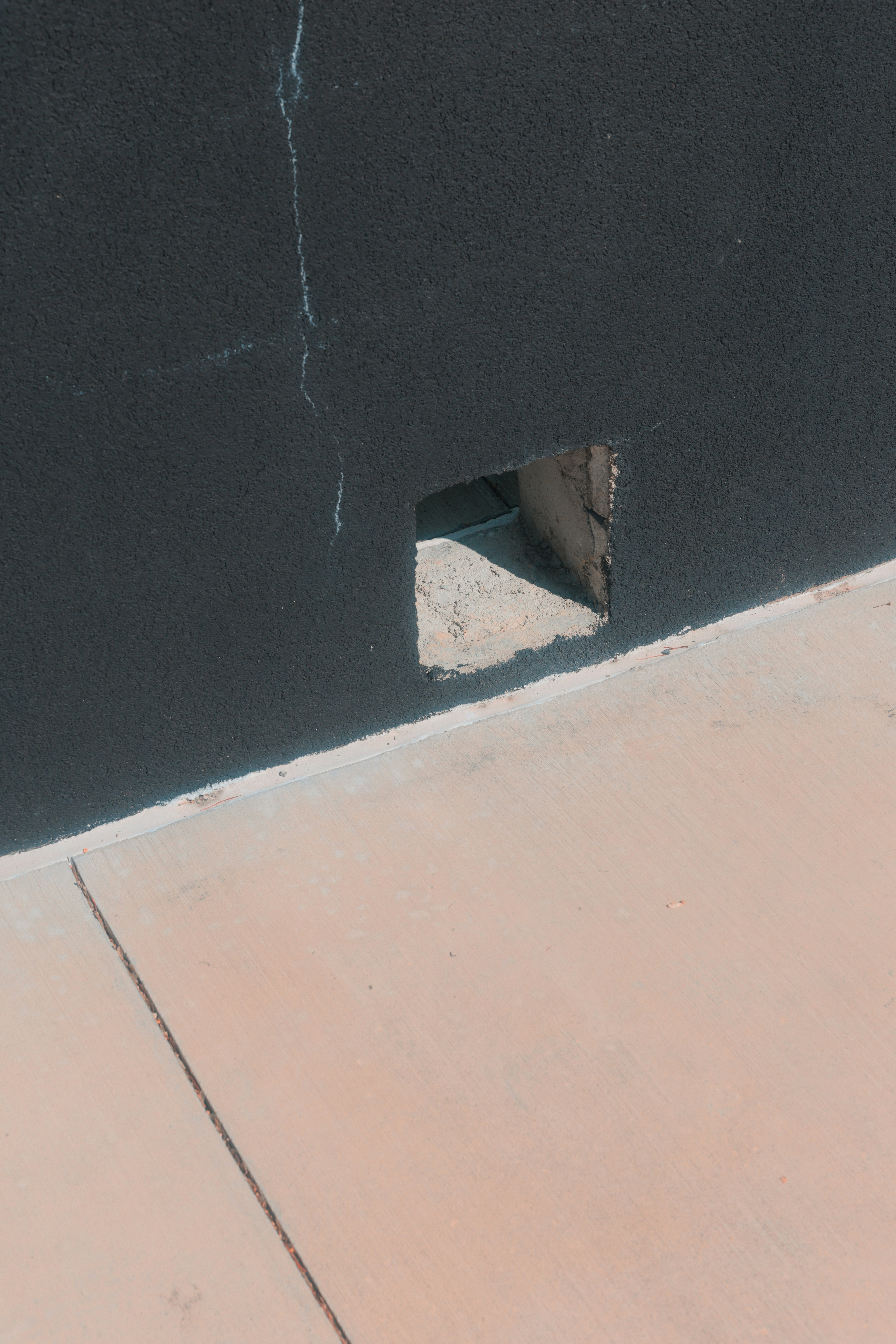 A hole in the wall shows a small void.