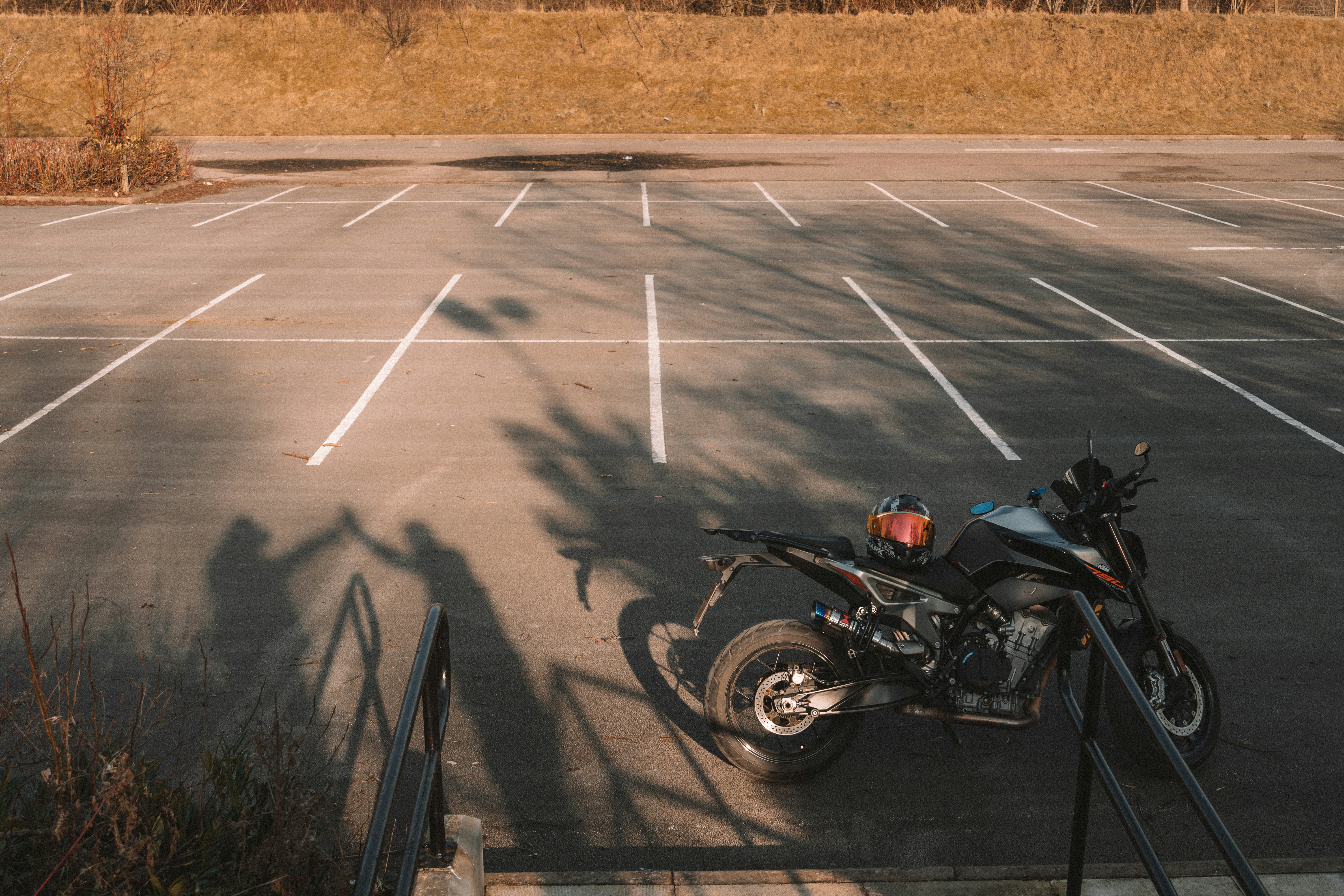 Motorcycle parked in an empty parking lot.