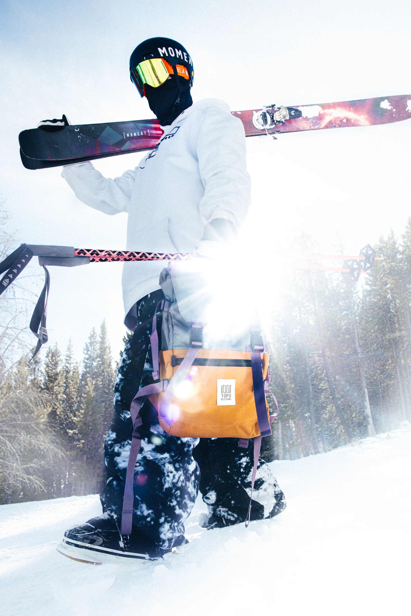 A snowboarder descends a wide snow-covered slope.