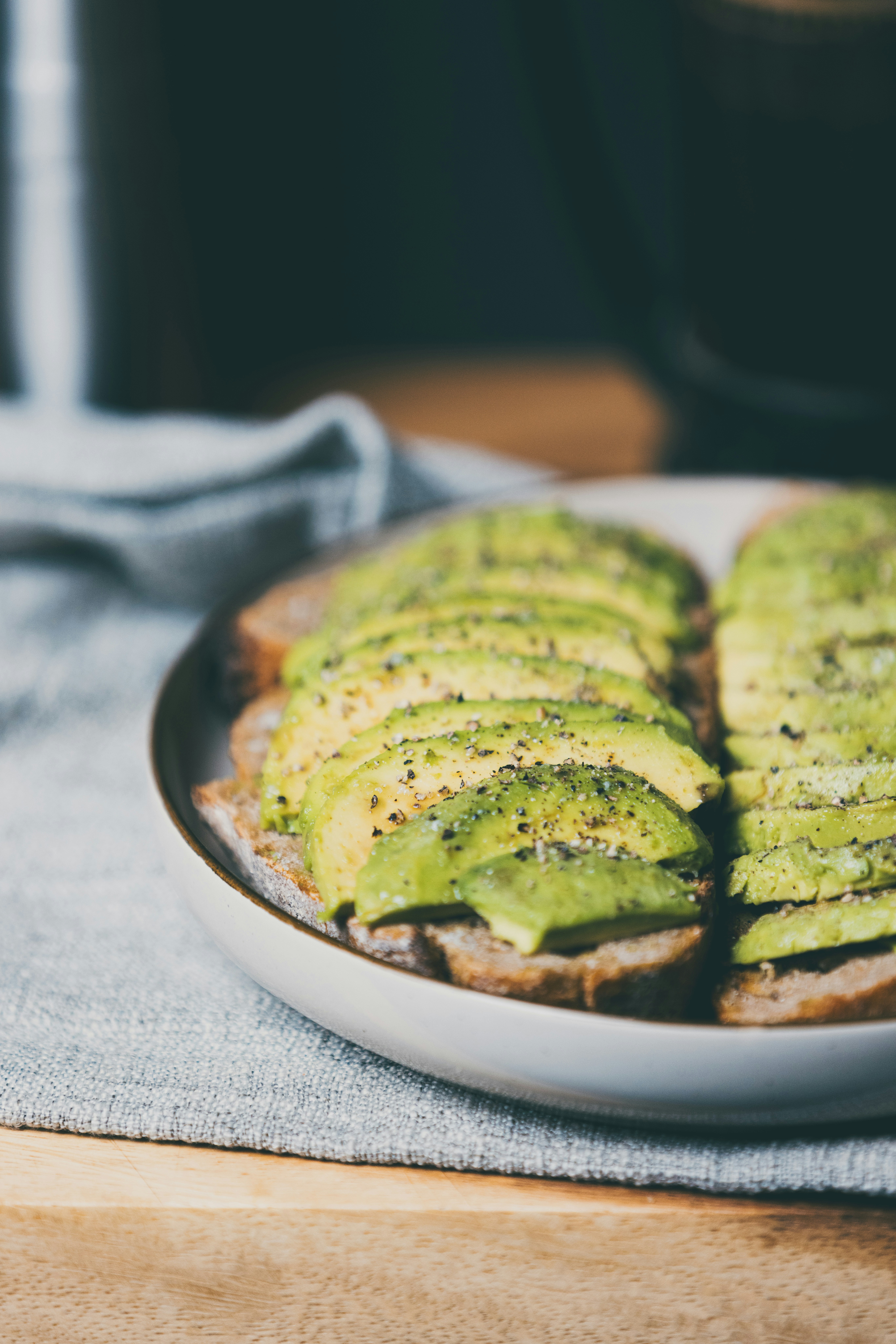 Avocado toast sits on a plate.