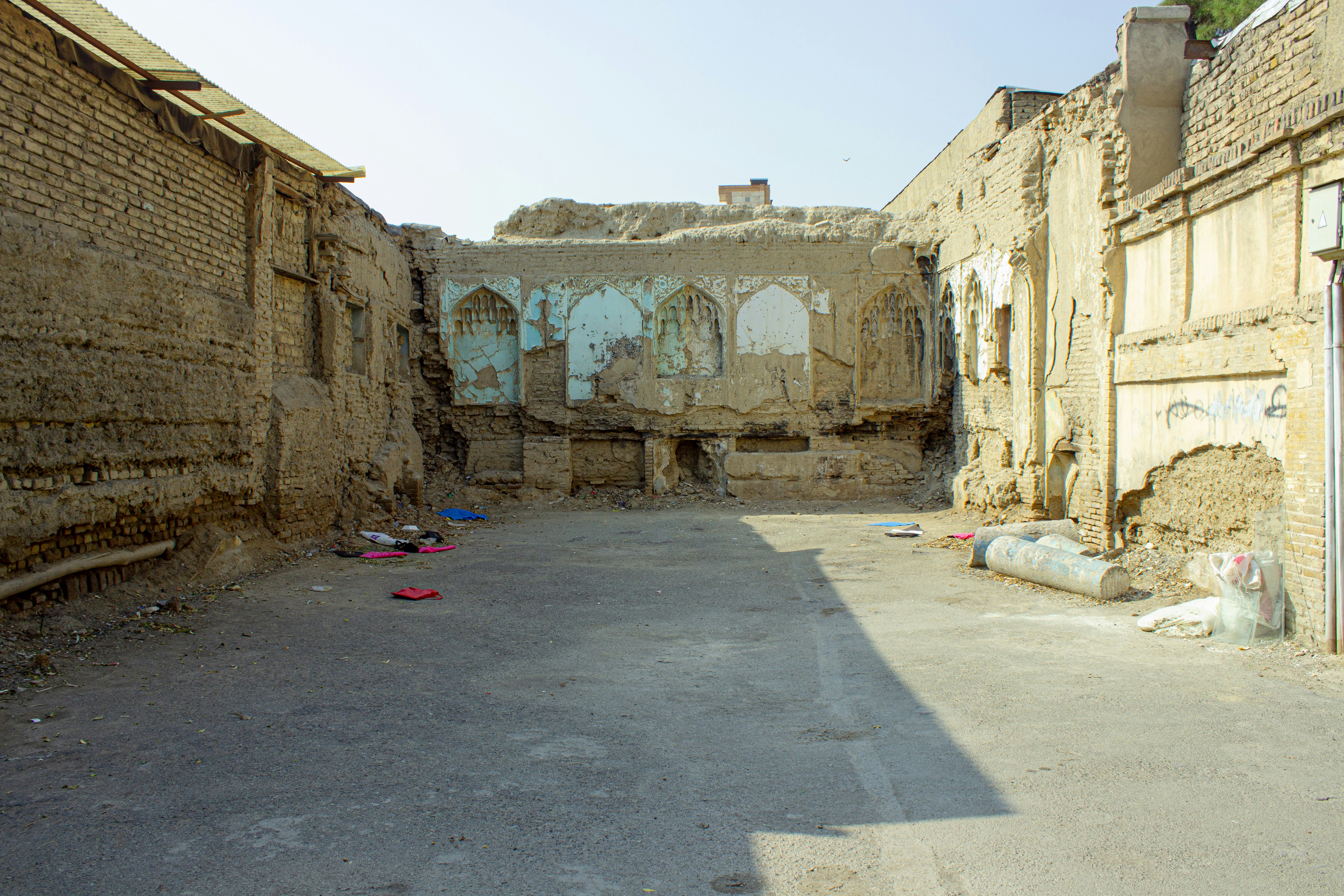 Ruins of an old building stand in sunlight.