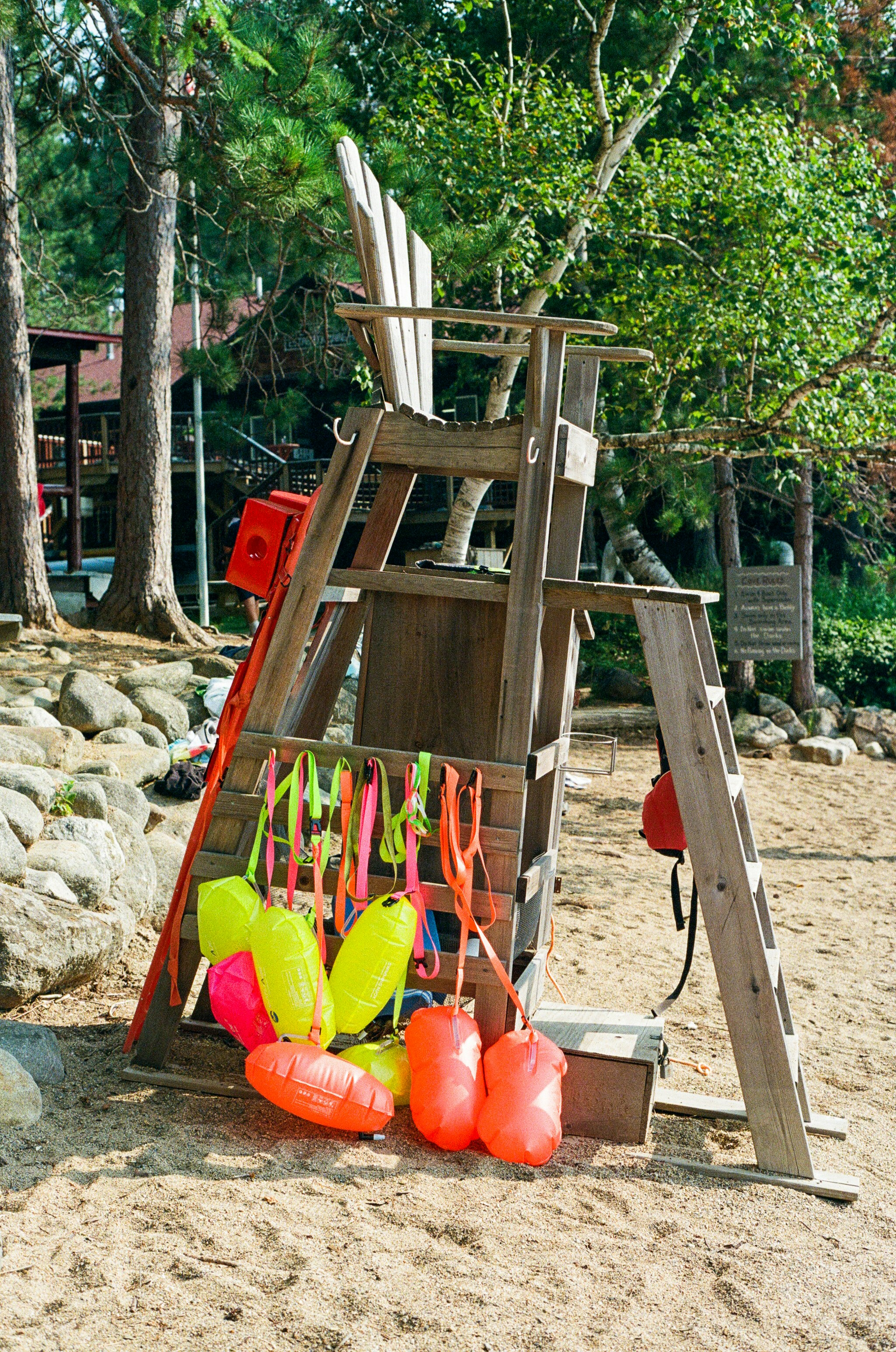 Lifeguard stand with equipment on a sandy beach.