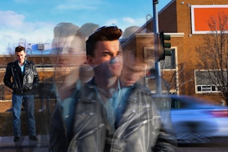 Blurred image of a man walking down the street.