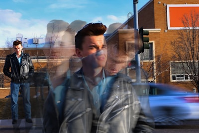 Blurred image of a man walking down the street.