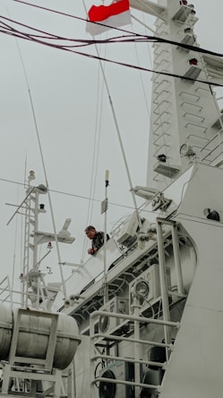 Man on a ship with a flag.