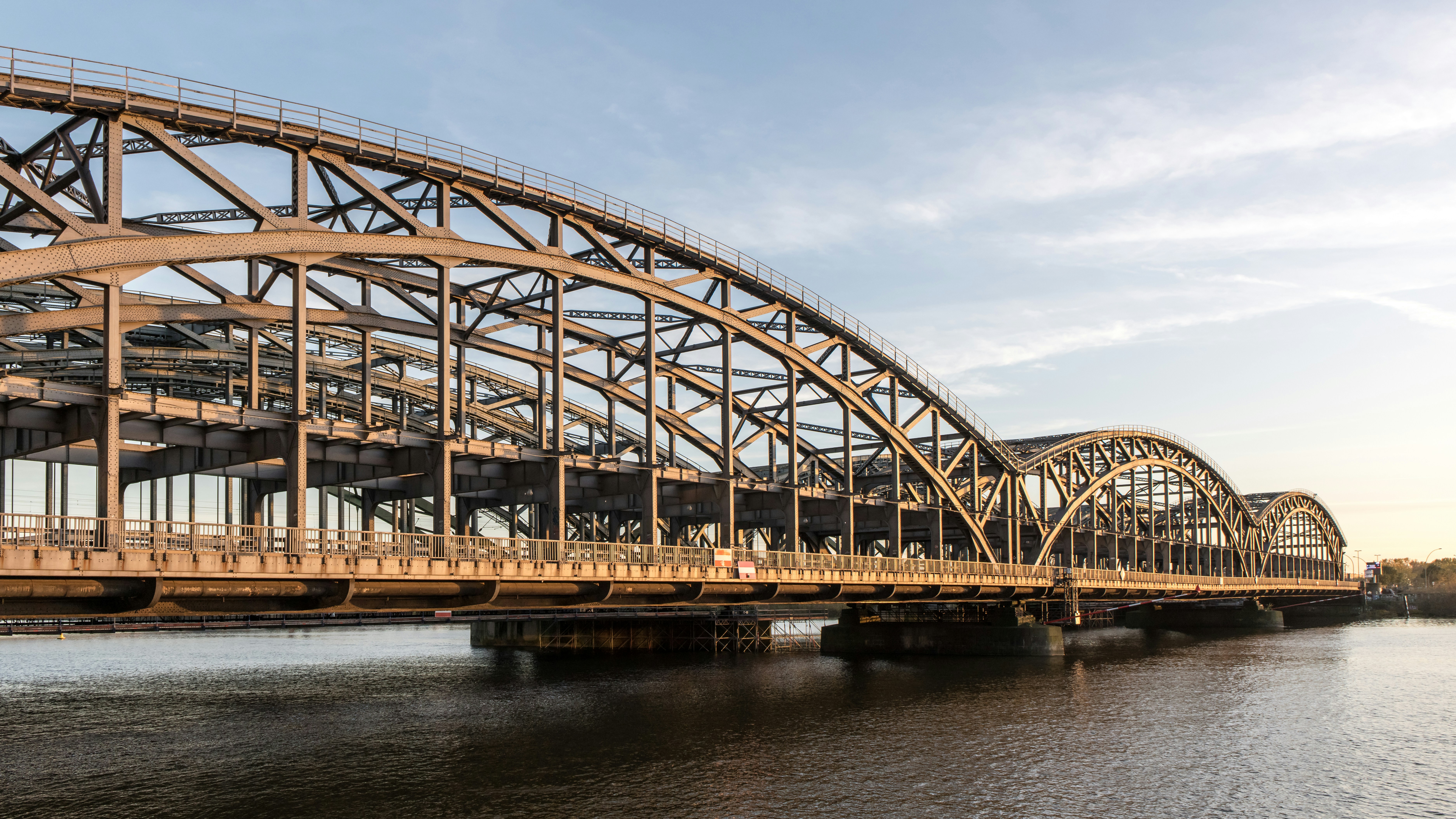 A large, arch bridge spans a body of water.