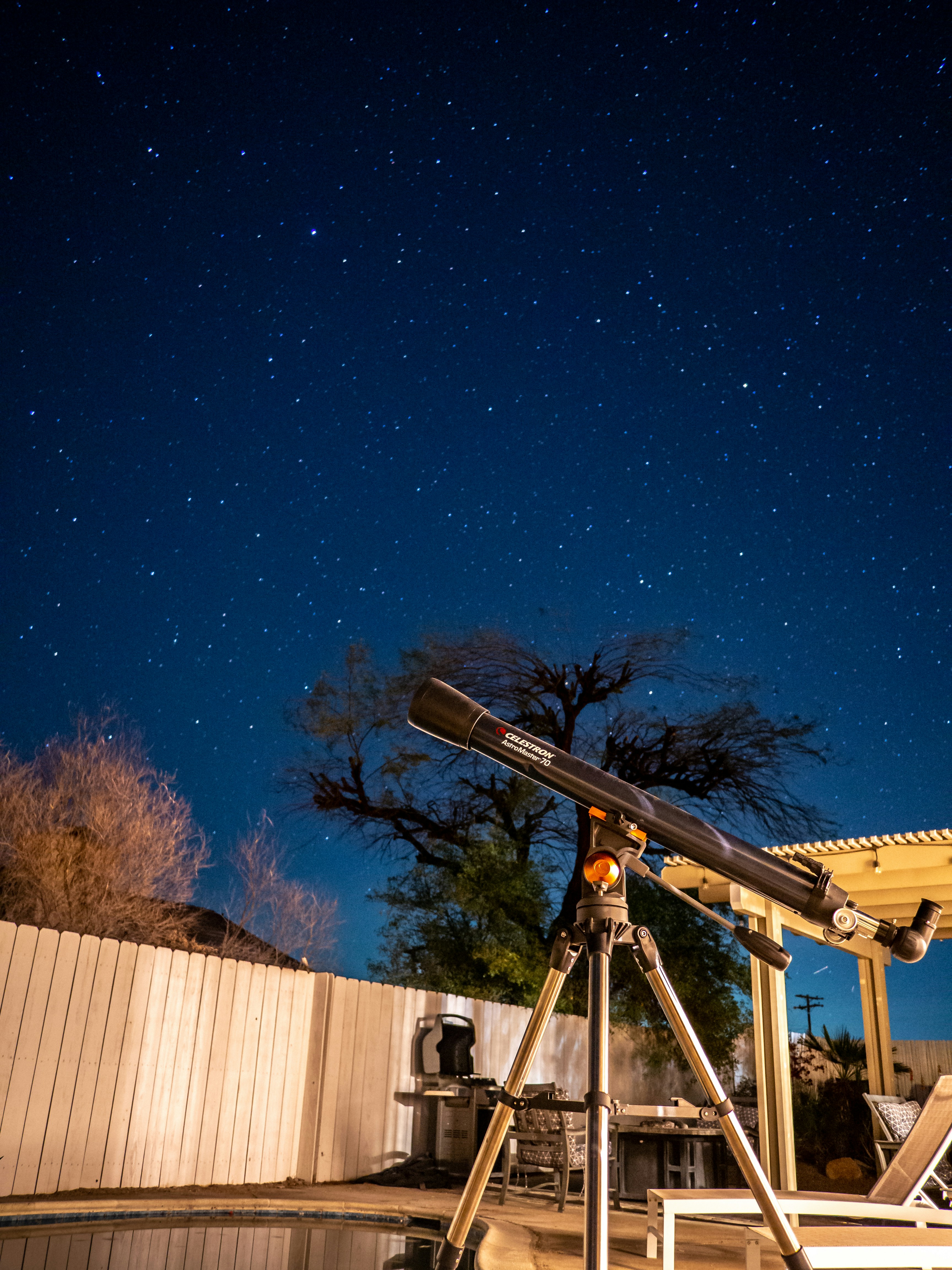 Telescope pointed at the starry night sky
