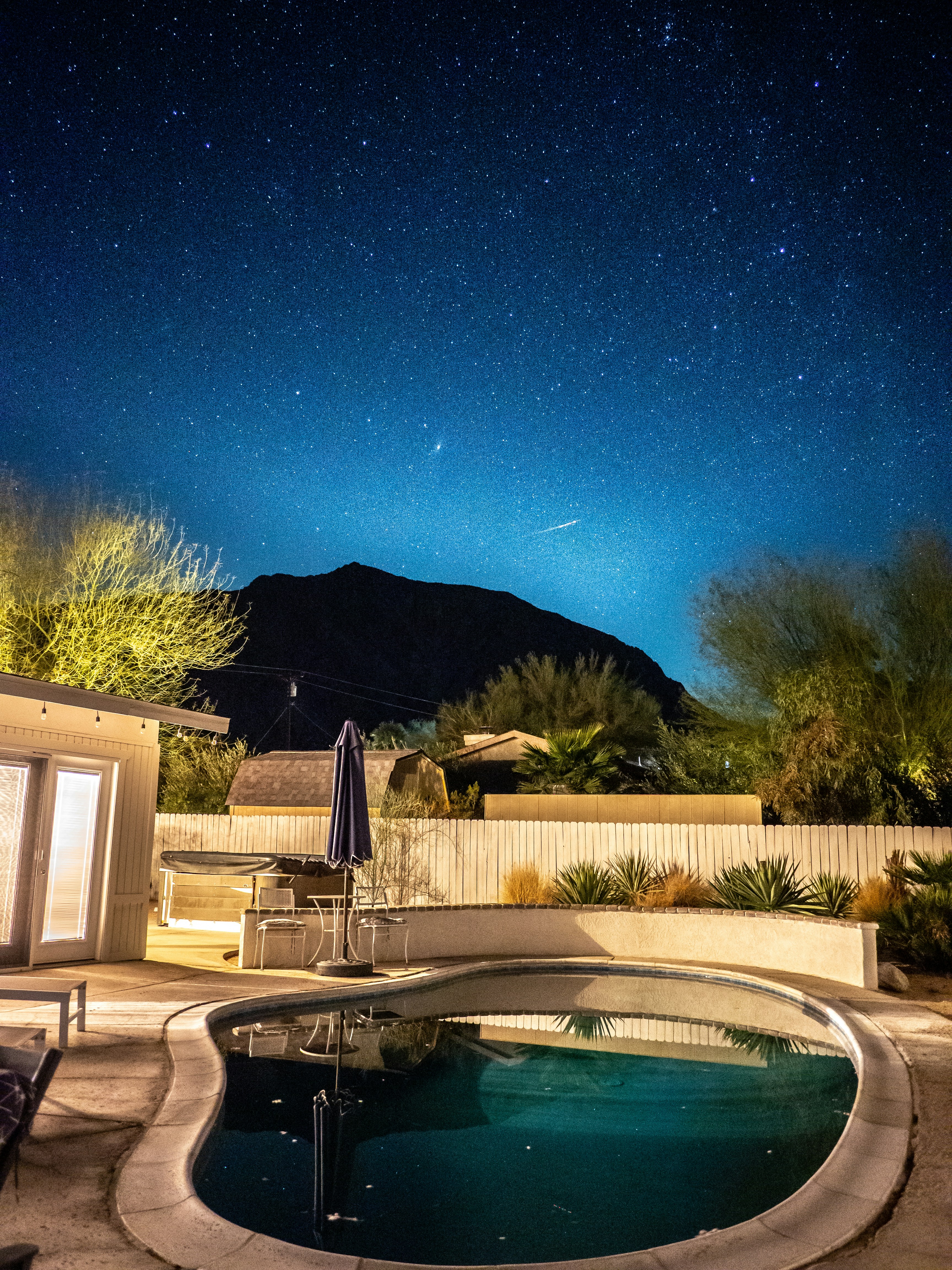 Swimming pool reflecting the starry night sky