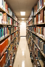 A library aisle filled with many books.