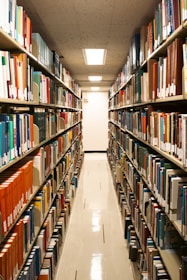 A library aisle filled with many books.