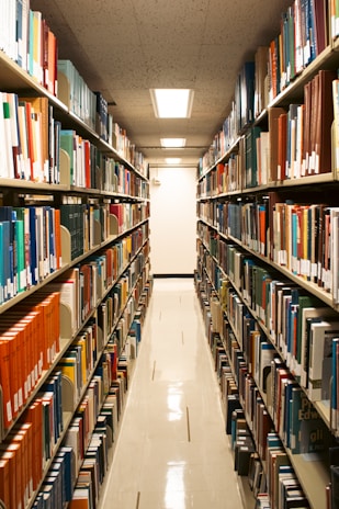 A library aisle filled with many books.