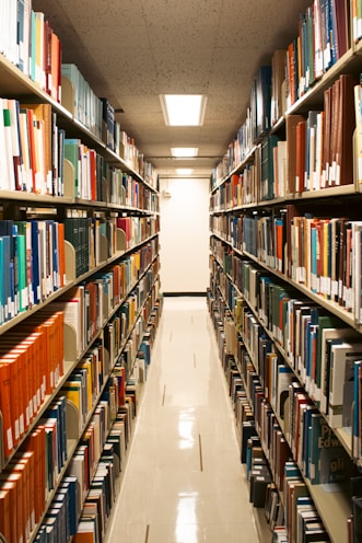 A library aisle filled with many books.