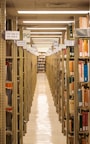 A long library aisle lined with books.