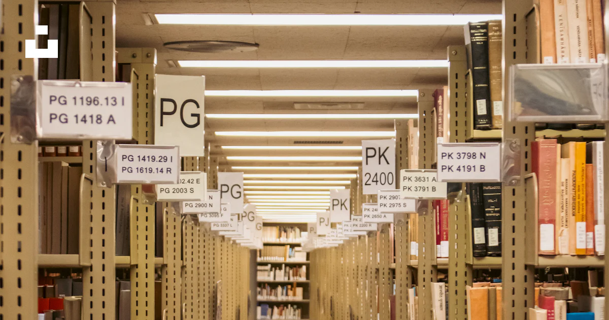 A long library aisle lined with books. photo – Free Books Image on Unsplash
