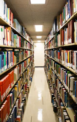 A library aisle lined with many books.
