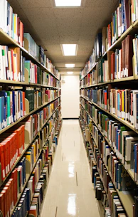 A library aisle lined with many books.