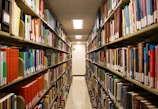 Rows of books fill a library aisle.
