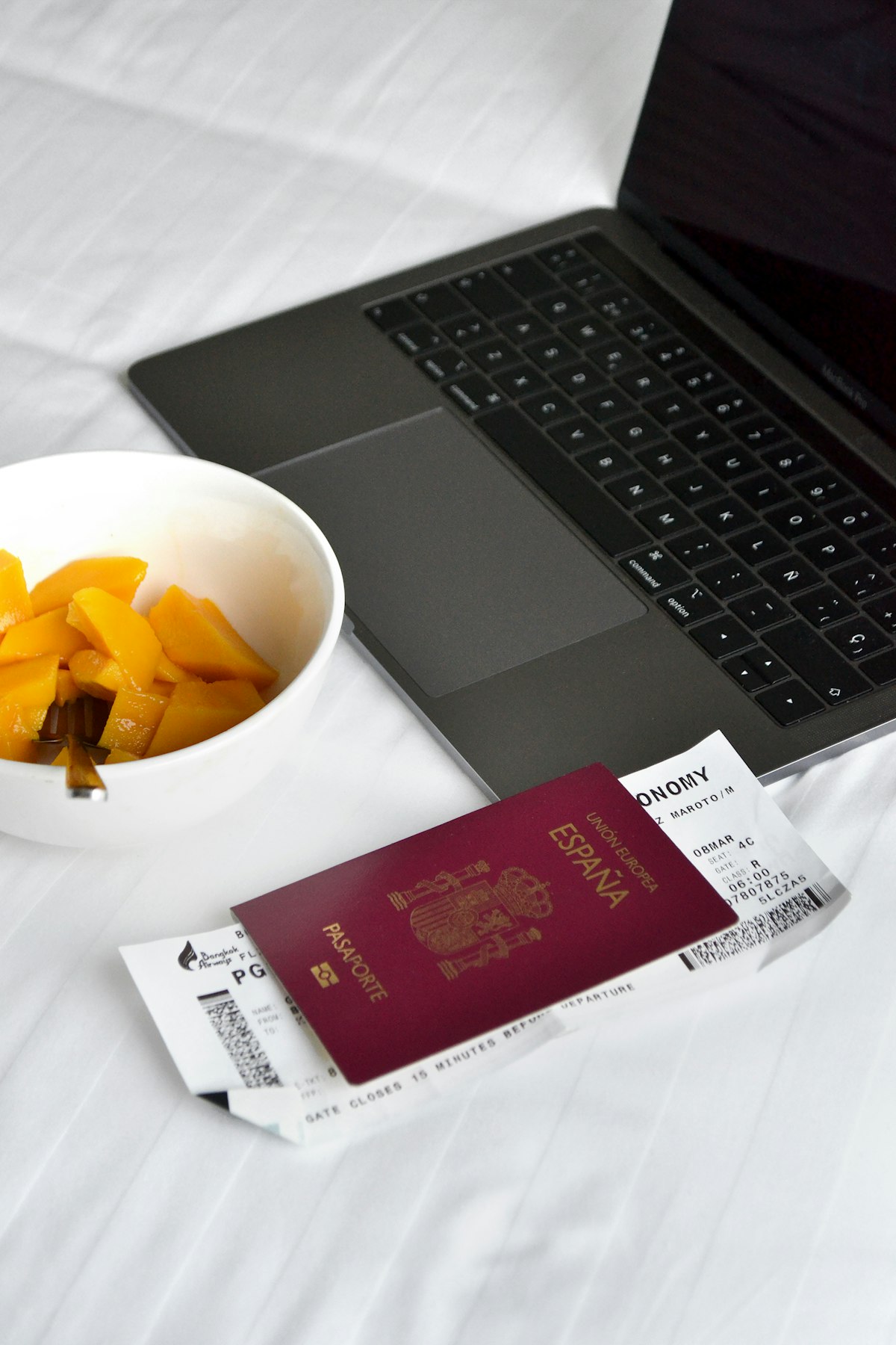 Travel essentials with a passport and laptop representing Airbnb's booking platform growth