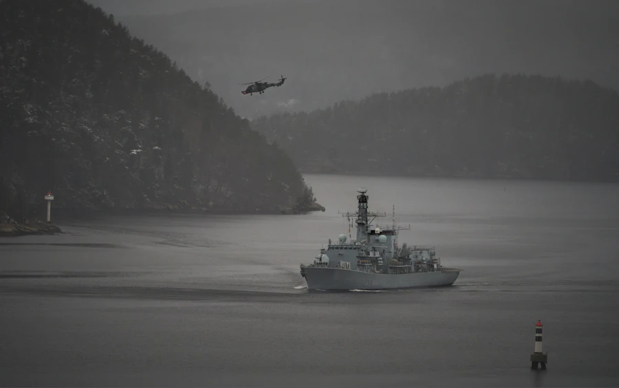Naval vessel with helicopter overhead