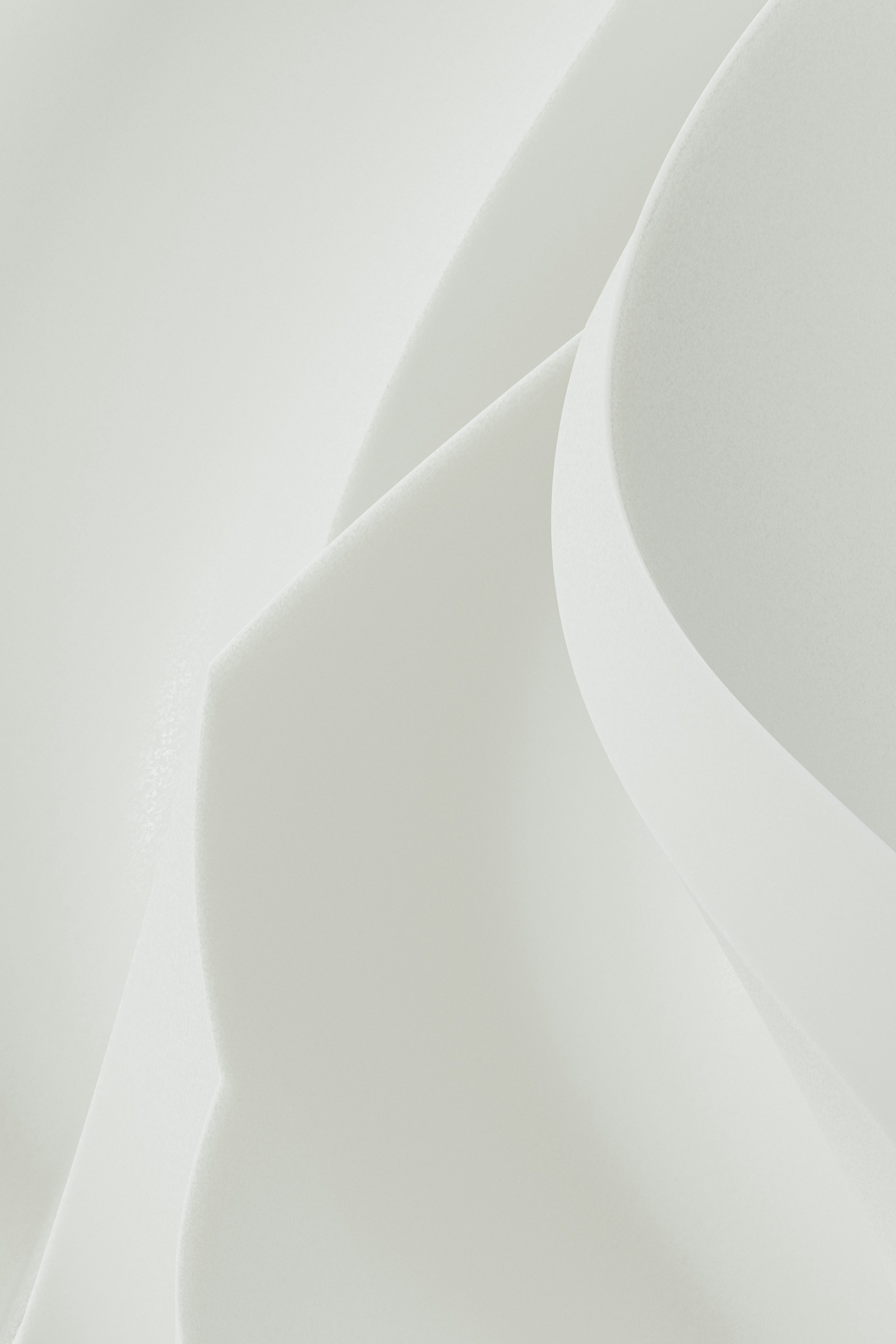 Abstract shapes of white paper gently curving.