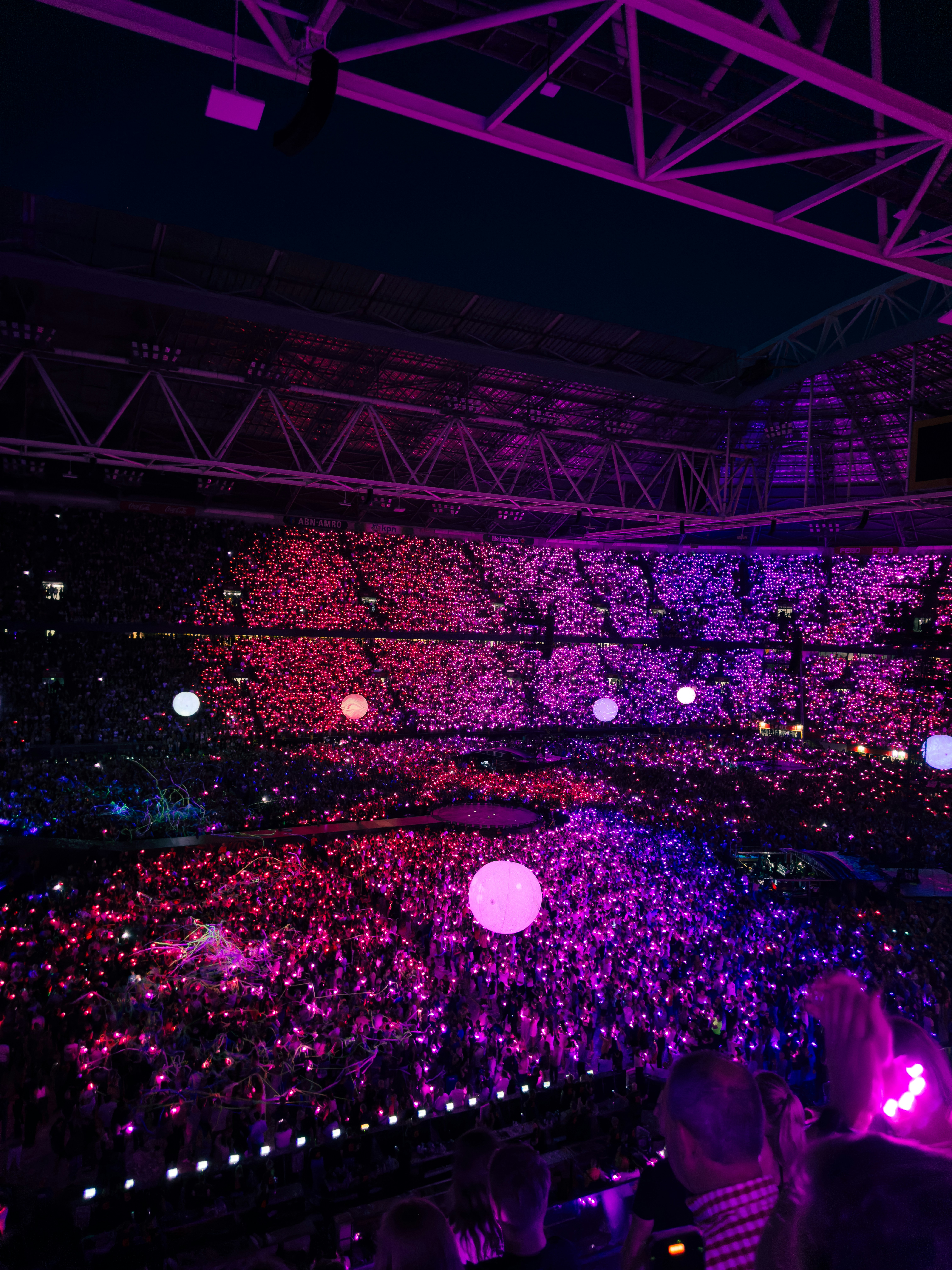 Concert arena lit up in purple lights.