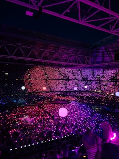 Concert arena lit up in purple lights.
