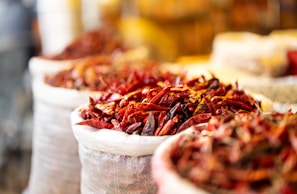 Dried chili peppers are displayed in bags.