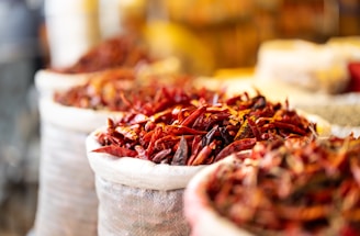 Dried chili peppers are displayed in bags.