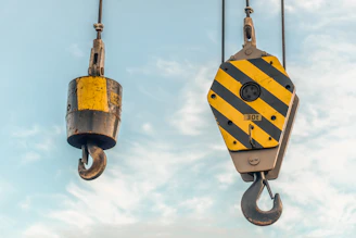 Crane hooks hanging in the sky.