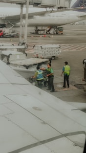 Ground crew loading baggage onto an airplane.