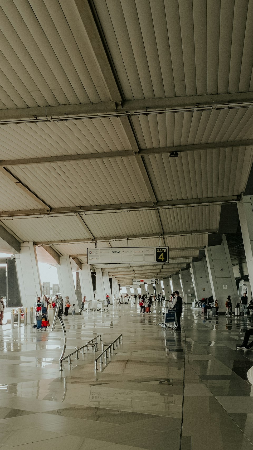 Travelers walking through a bright modern airport terminal