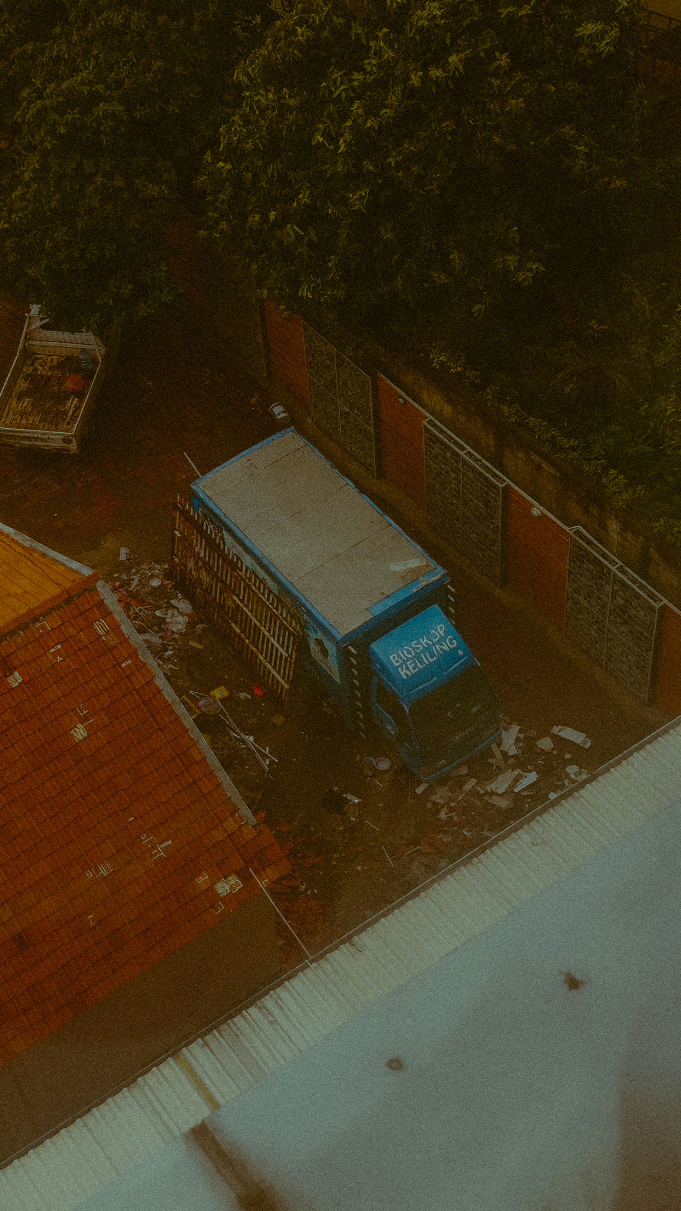 A garbage truck is seen down a street.