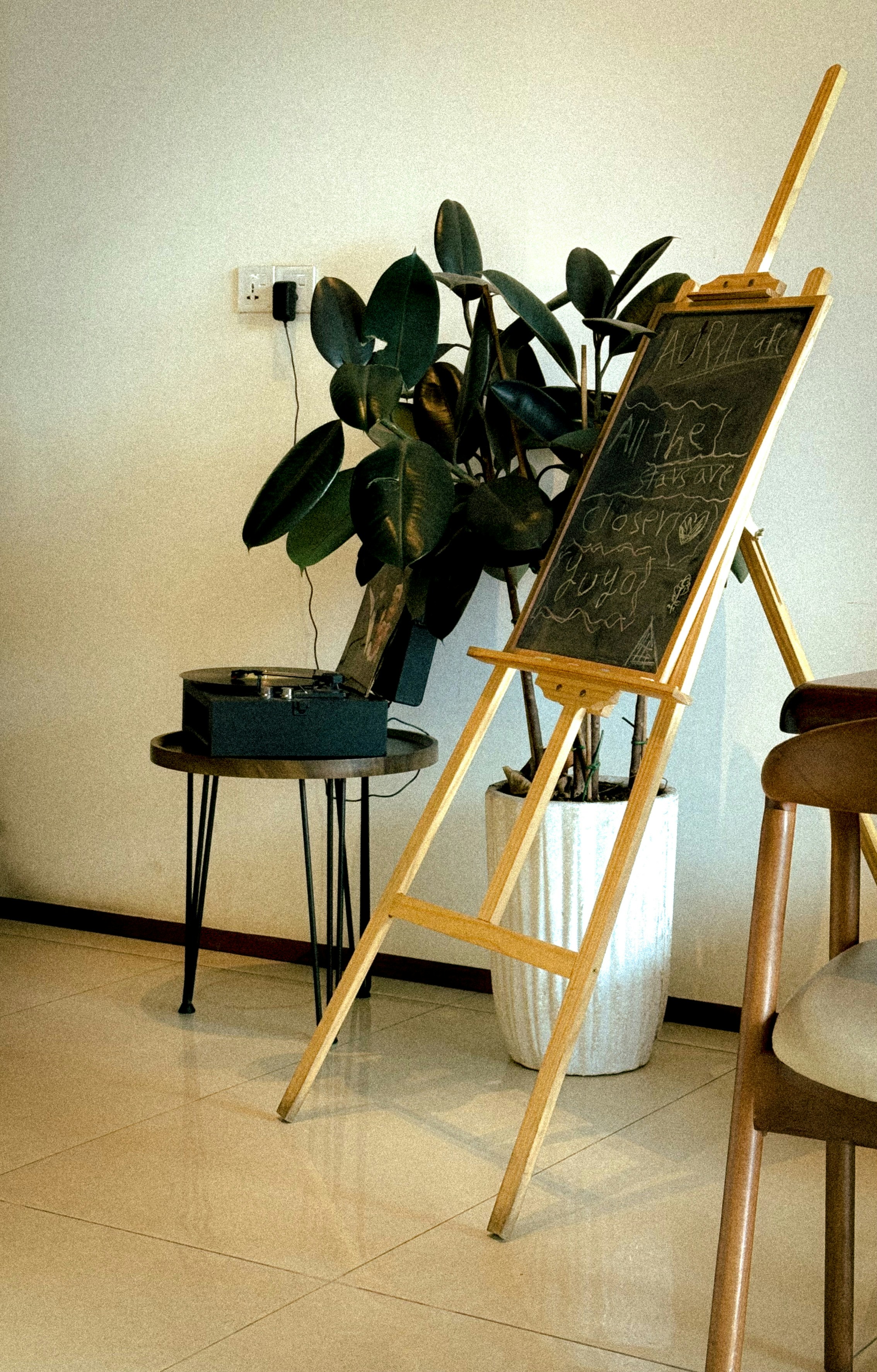 Wooden easel holding a chalkboard in a cafe.